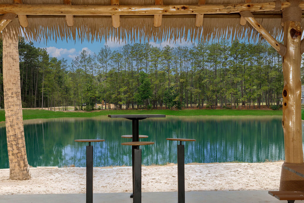 a table and stools by a body of water
