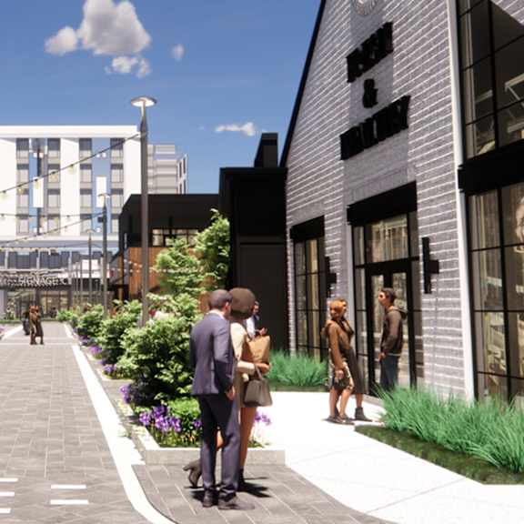 A street view of a city with people walking and talking at The Union Flats at Fishers District, Fishers