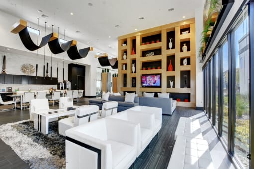 A large lounge area near the coffee bar with chairs and couches and glass window view