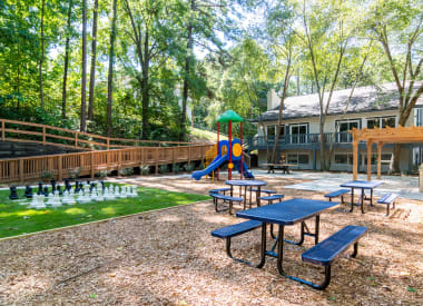 Picnic spaces with tables and green surroundings at Wyndcliff Galleria apartment community in Smyrna GA