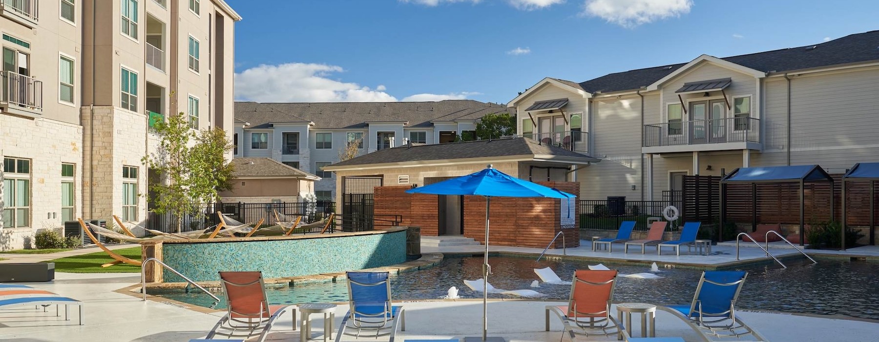 a swimming pool with lounge chairs
