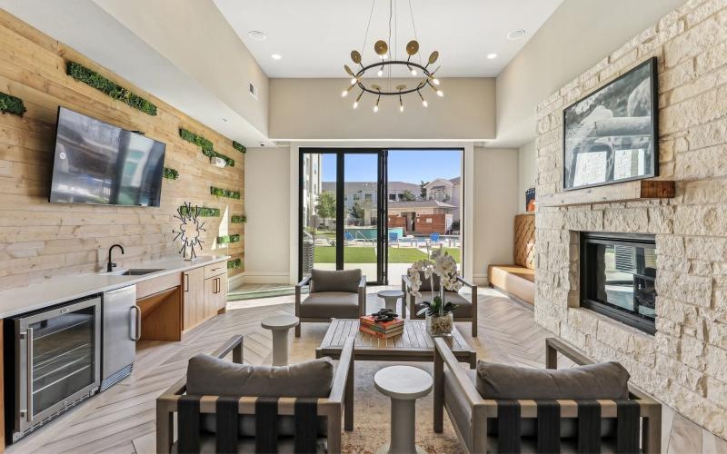 a clubroom with tv's, chairs and tables