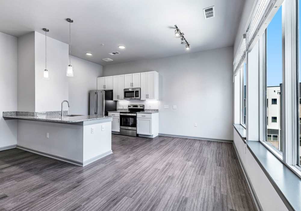 Kitchen with white cabinetry at The Rail Apartments in Austin, Texas