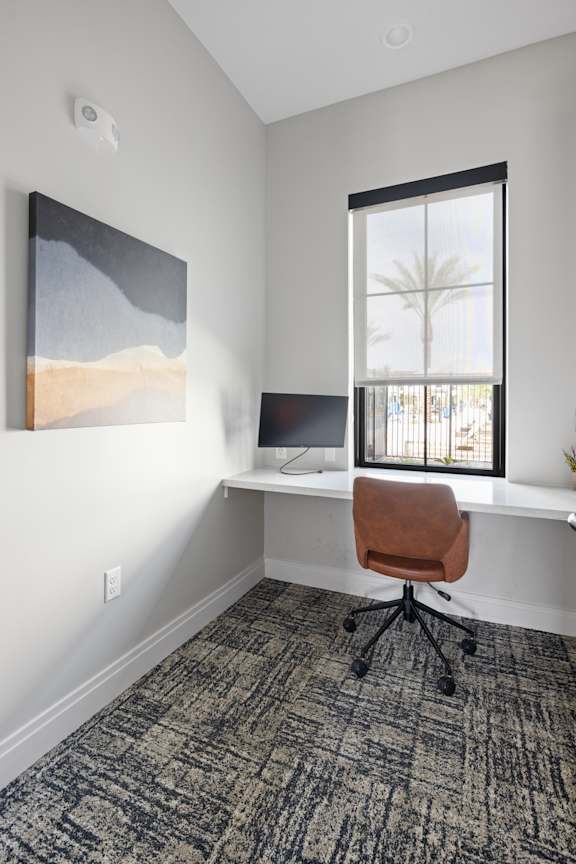 A room with a desk and a painting on the wall.at Stella, San Tan Valley Arizona