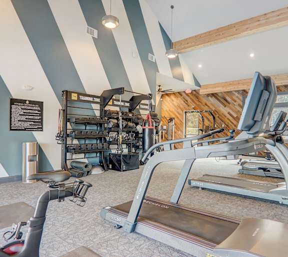 A gym with treadmills and exercise bikes.