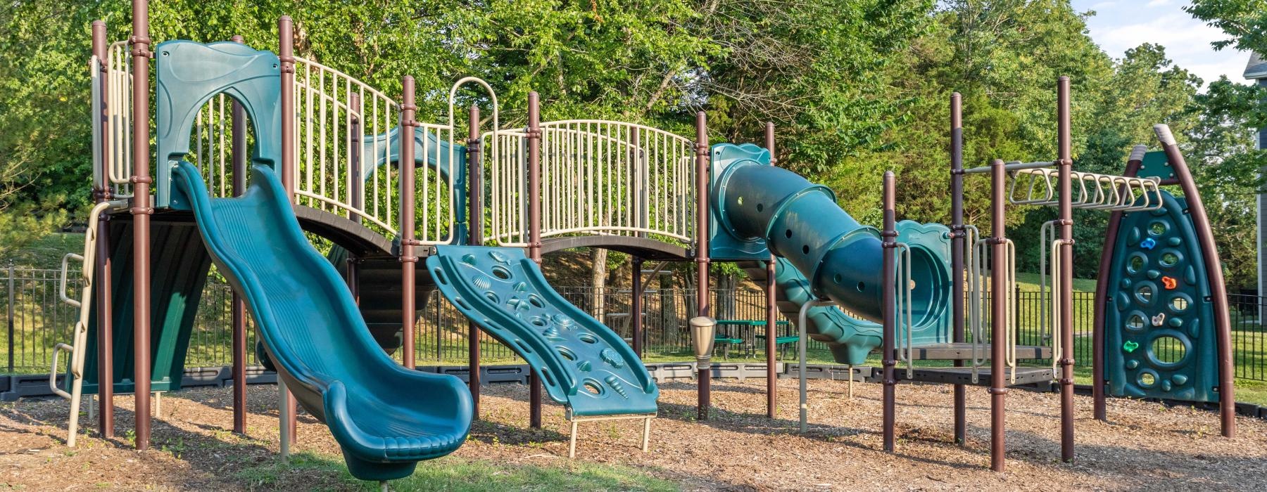 a playground with trees and grass