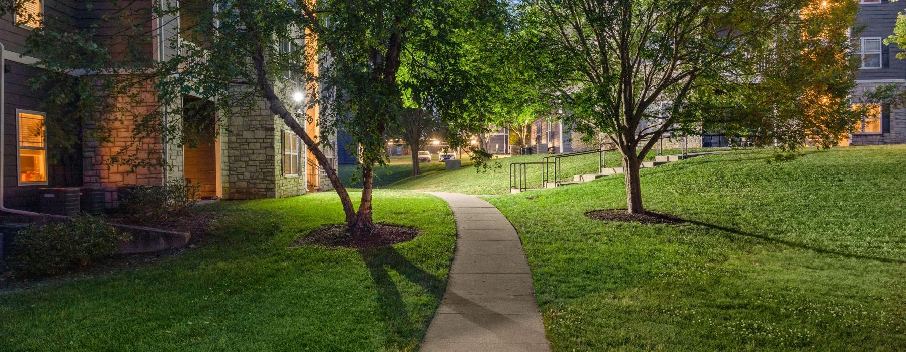a sidewalk and grass next to a building