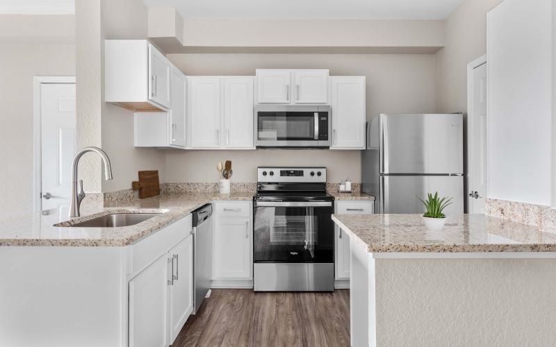 a kitchen with white cabinets