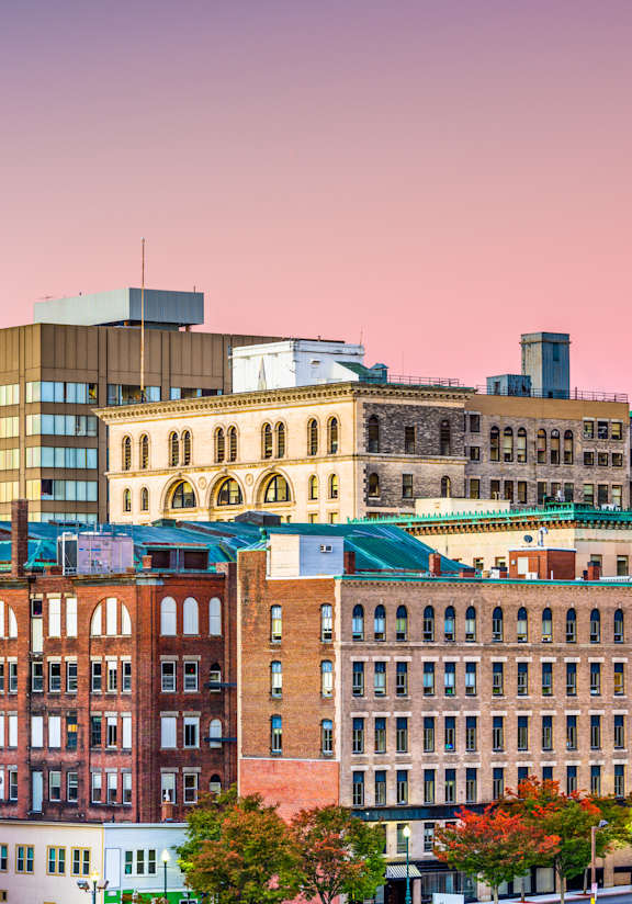 A cityscape with a mix of modern and older buildings.
