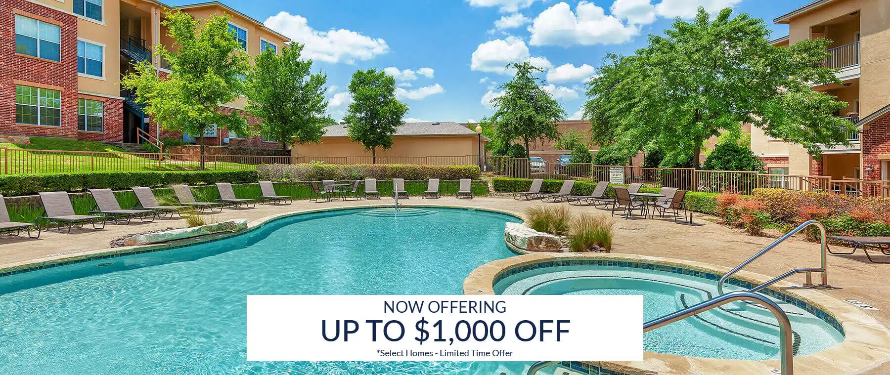 Experience the relaxing ambiance of Bella Ruscello’s outdoor swimming pool and hot tub area, surrounded by inviting lounge chairs at this elegant apartment complex. Lush trees, manicured grass, and multi-story buildings create the perfect setting under a partly cloudy sky. Don’t miss our exclusive discount offer—make Bella Ruscello your new home today!.