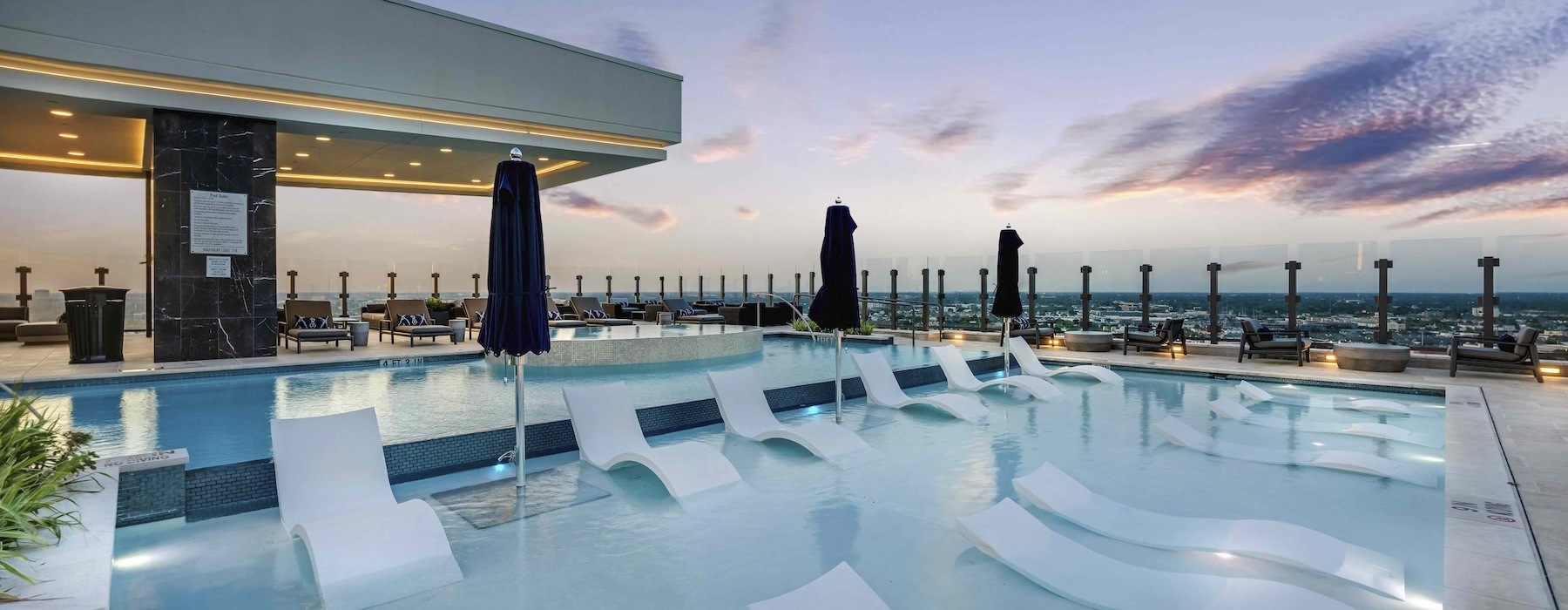 a large pool with chairs around it
