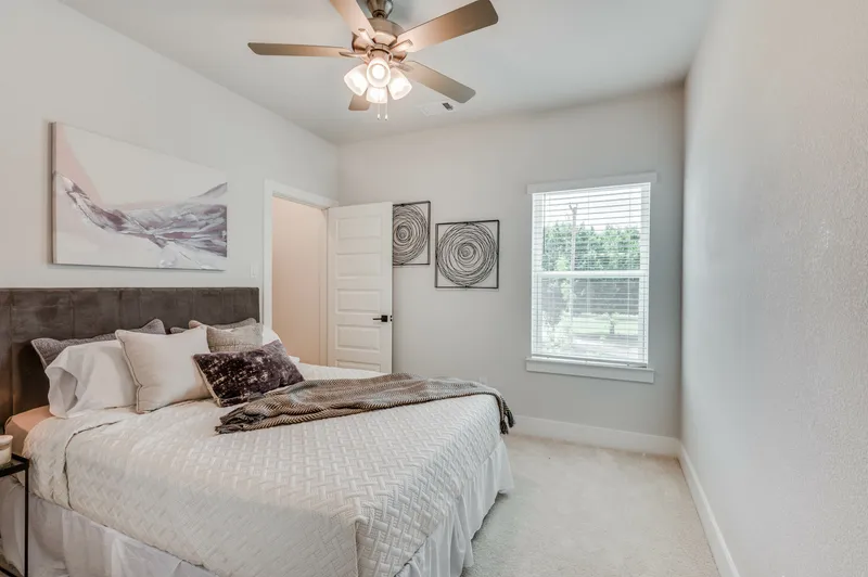 furnished guest bedroom with ceiling fan