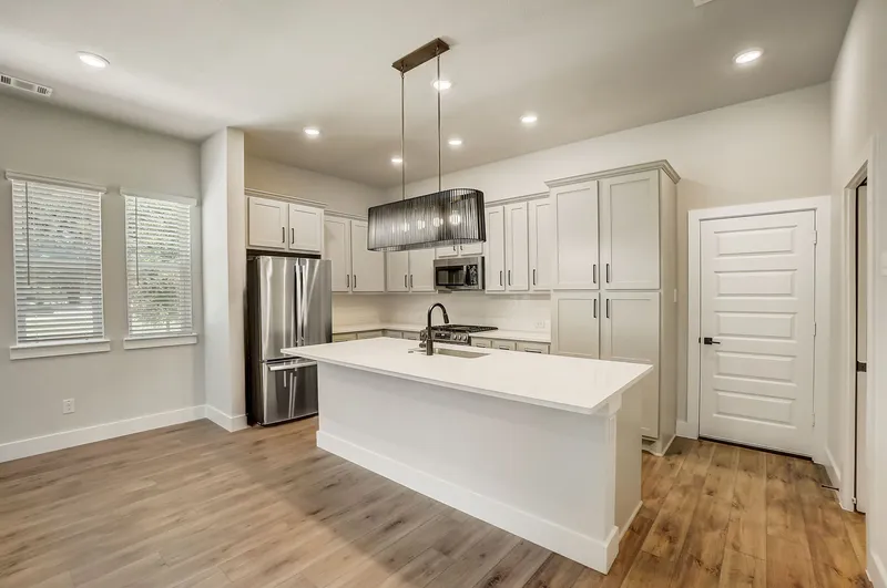 kitchen with island and stainless steel appliances and wood style flooring