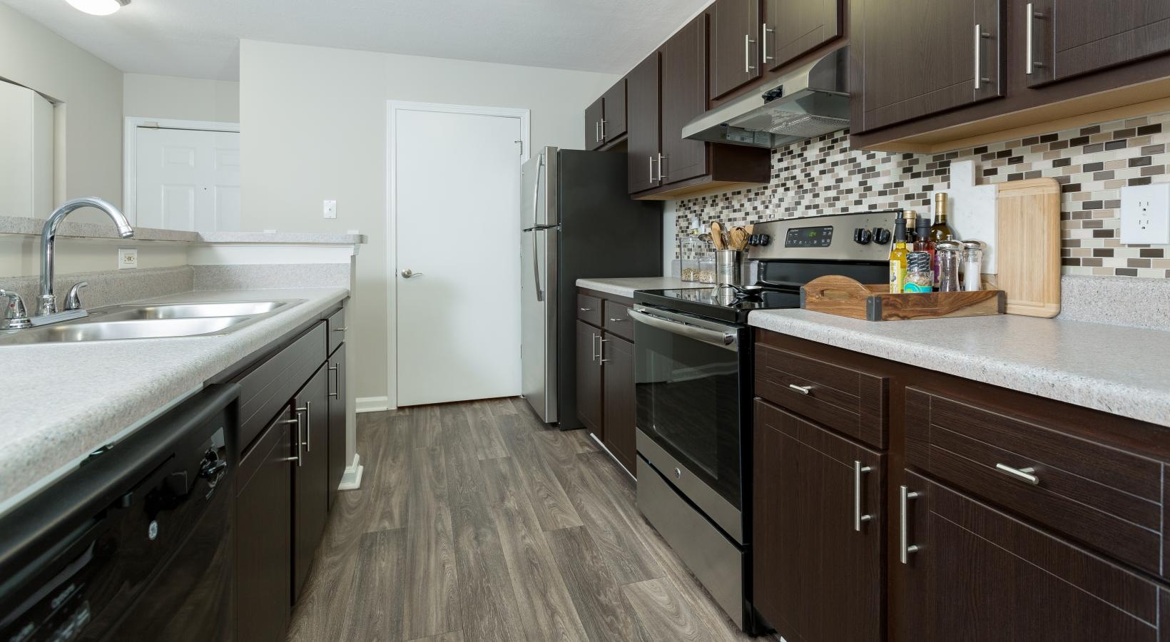 a kitchen with wooden cabinets
