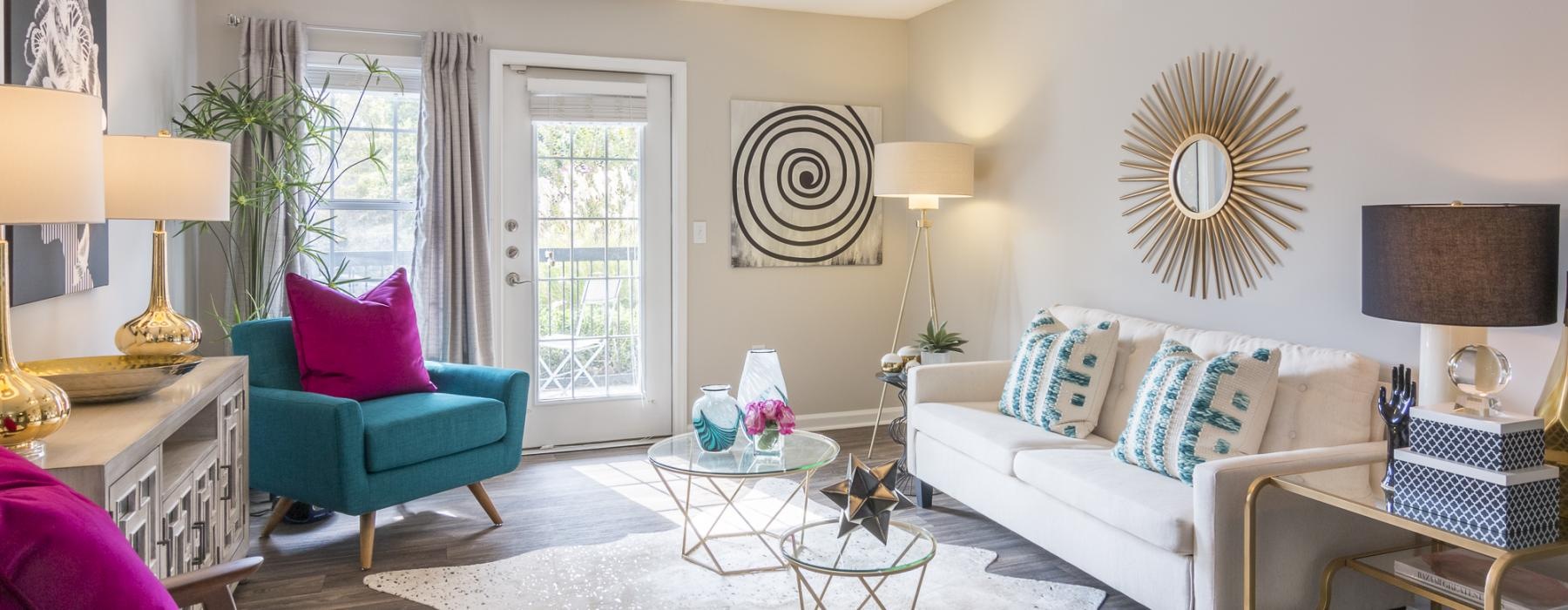 a living room with a fan and couches