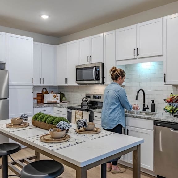 a kitchen and living room with a table and chairs
