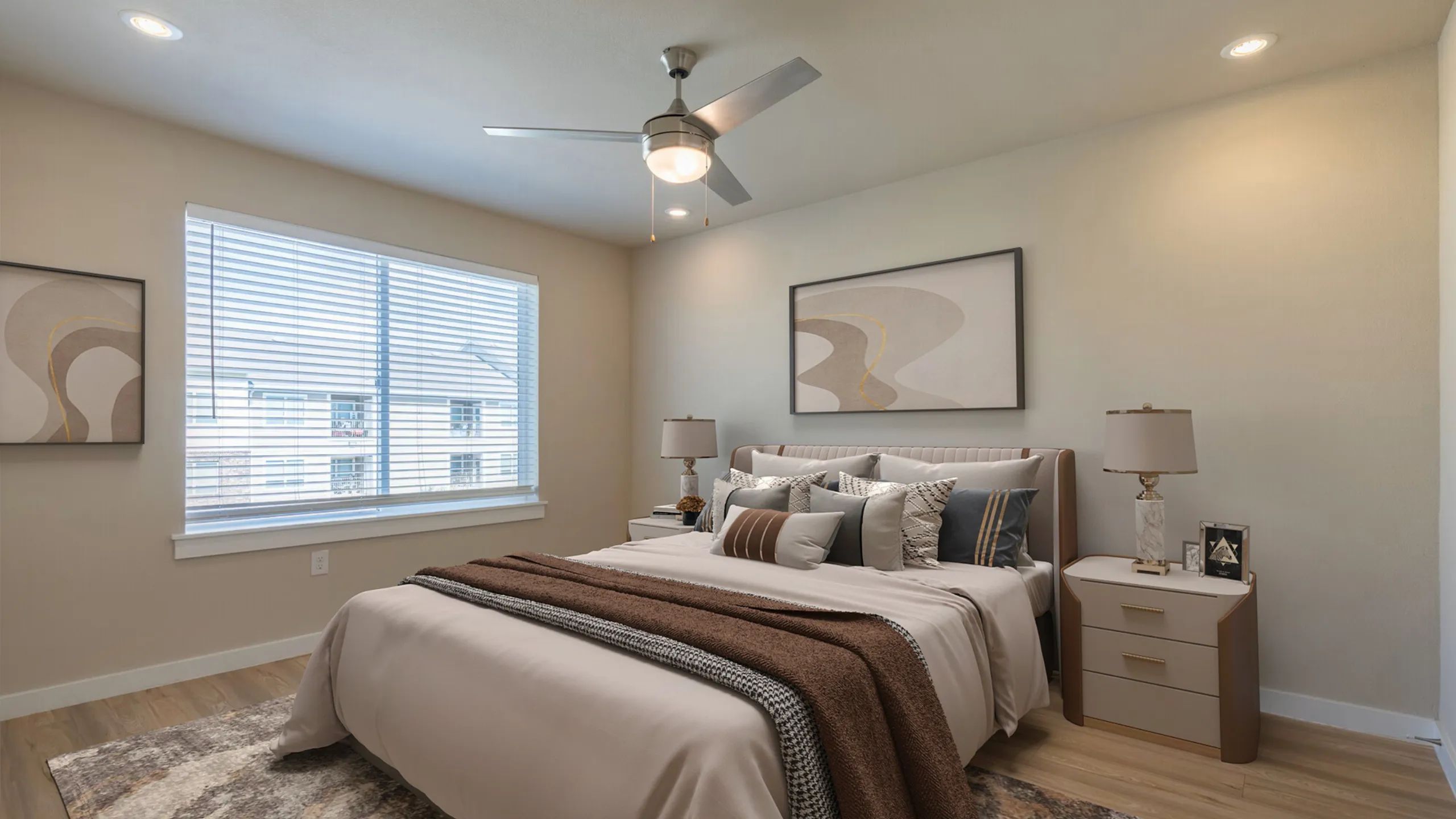 Inviting bedroom with a large window, elegant ceiling fan, plush bed, and stylish decor.
