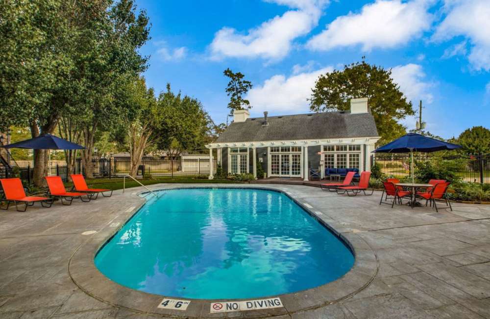 Swimming pool with lounge chair at Verena at Cypresswood in Spring, Texas