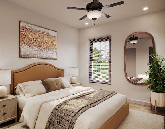 A bedroom with a large bed, a ceiling fan, and a painting on the wall.