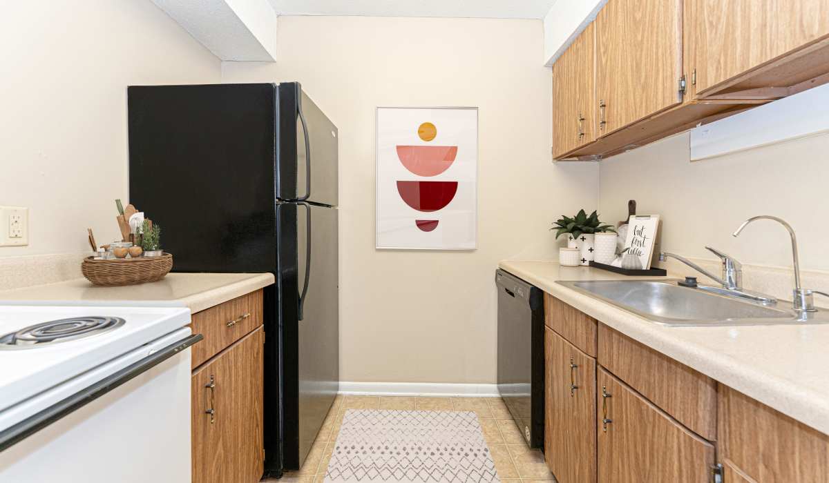 Cozy kitchen with wooden cabinetry at Columbia Crossing Apartments in Columbia, Missouri