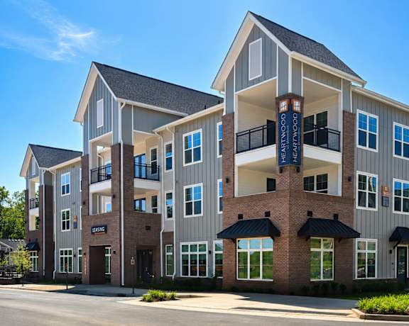 A large apartment building with a balcony on the second floor.