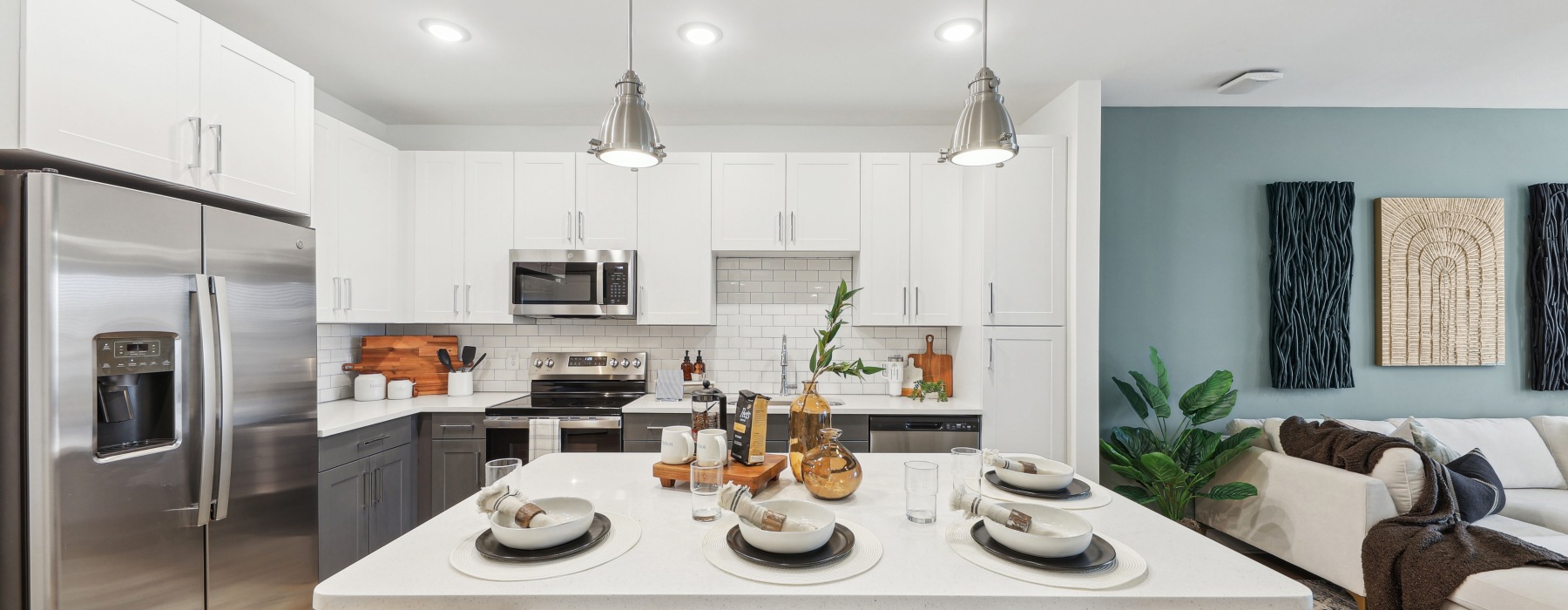 A kitchen with a kitchen island countertop and stainless steel appliances at The Hudson apartments near downtown Chattanooga, TN.