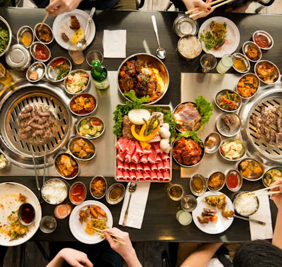 Dining table with variety of dishes at AVIA Lofts on Victors Way, Ann Arbor, MI 48108