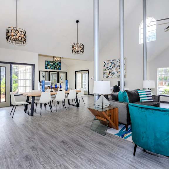 A spacious living room with a dining table and chairs.at The Davis Apartments, Huntsville, AL 35816