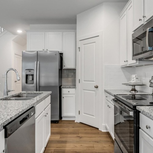a kitchen with white cabinets
