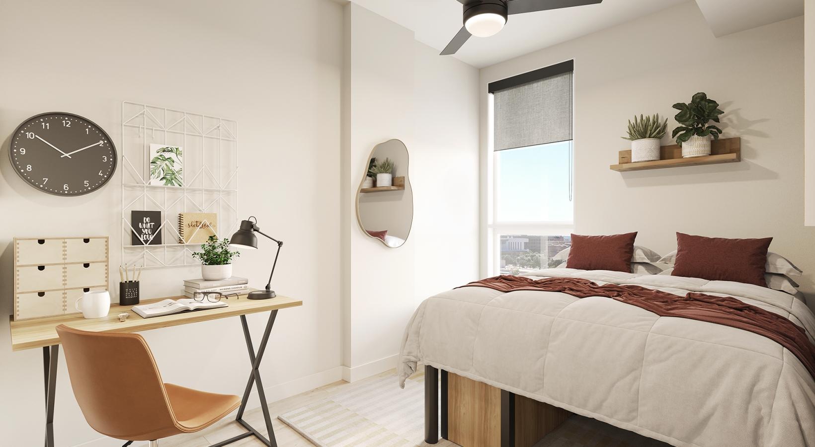 a bedroom with a bed desk and a mirror