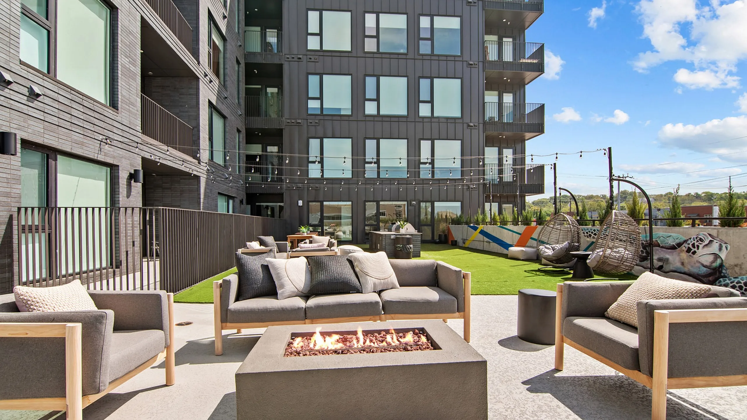 outdoor fire pit and green space with seating