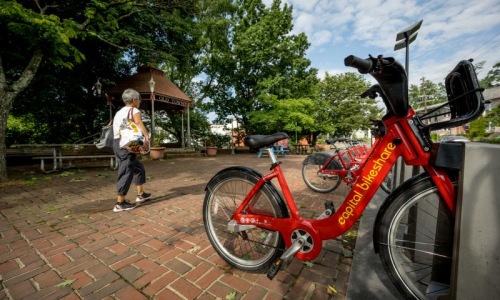 a person walking next to a bicycle