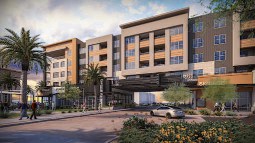 A rendering of a modern apartment complex with a car parked in front.at The Residences at The Gilmore in Gilbert, AZ
