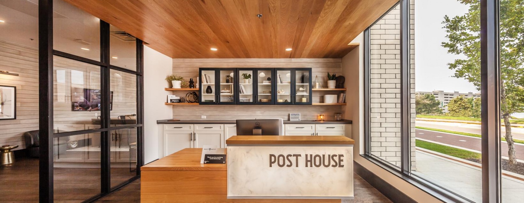 glass windows and walls surround Post House concierge desk