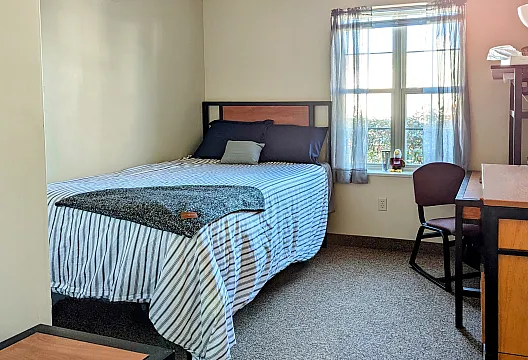 bedroom with bed with a striped comforter