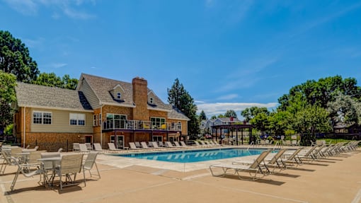 A large house with a pool in front.