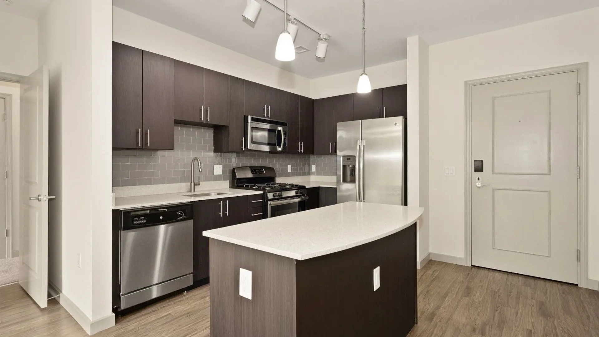 Kitchens with stainless steel appliances, ample cabinet storage, and modern tile backsplash