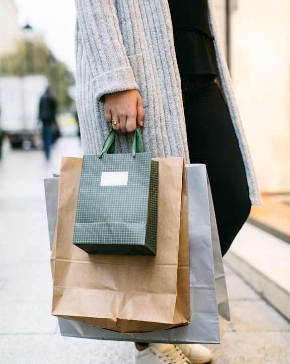 a person holding multiple shopping bags at Sunset Winds in Henderson, Nevada