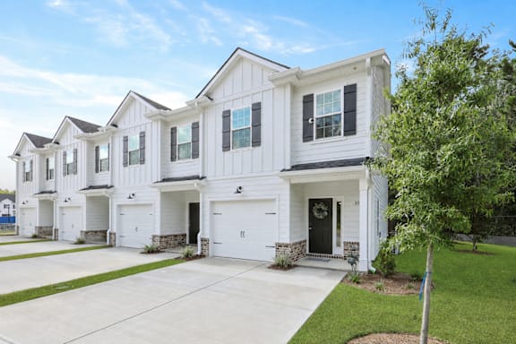 A white two-story house with a garage.