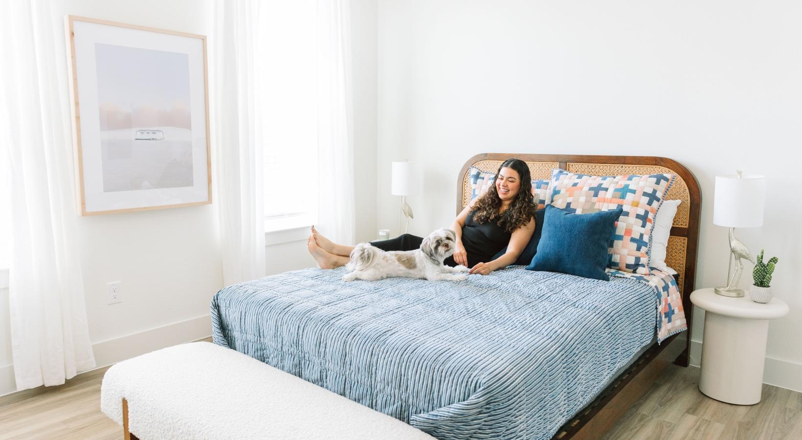 a person and a dog on a bed