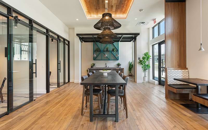 The meeting room at our apartments for rent in San Jose, CA, featuring a conference table with chairs and a TV.