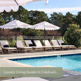 a swimming pool with lounge chairs and umbrellas