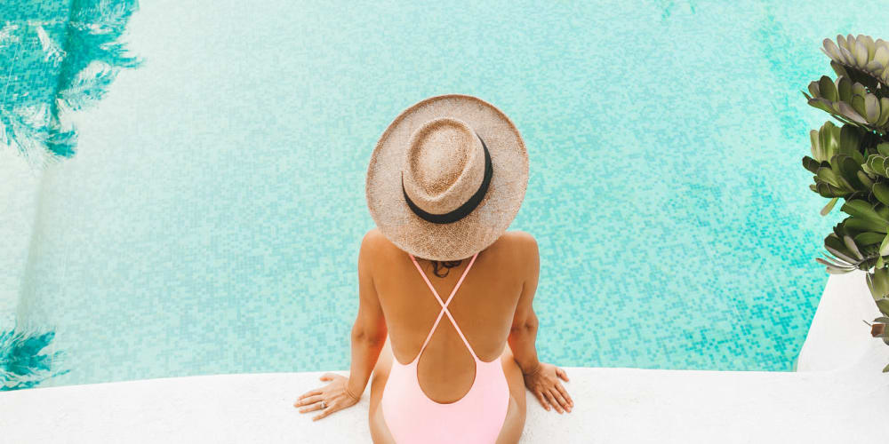 Resident relaxes next to the swimming pool at Olea Beach Haven in Jacksonville, Florida