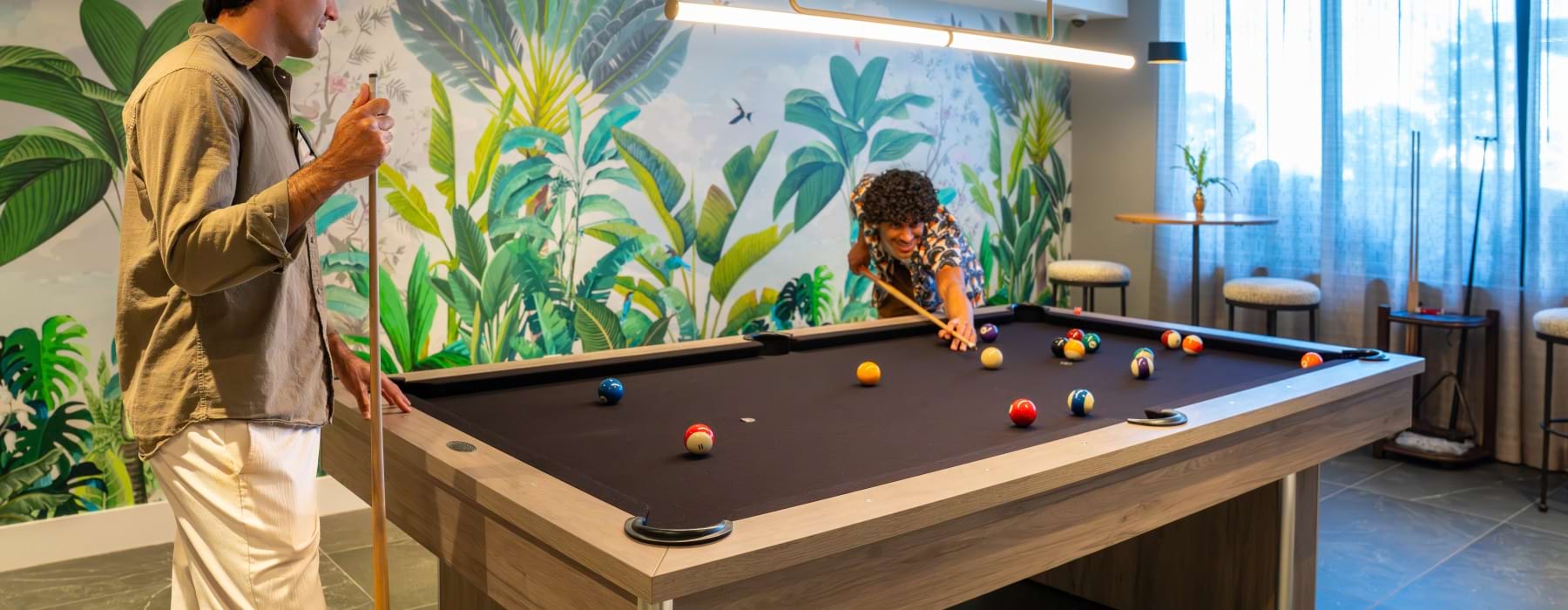 Modern resident game room with billiards table at The Holly at Soleste luxury apartments in Hollywood, Florida featuring upscale amenities and entertainment spaces near Hollywood Beach.