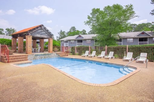 our apartments have a resort style pool with chairs and a gazebo
