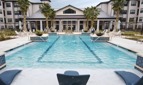 a swimming pool with lounge chairs