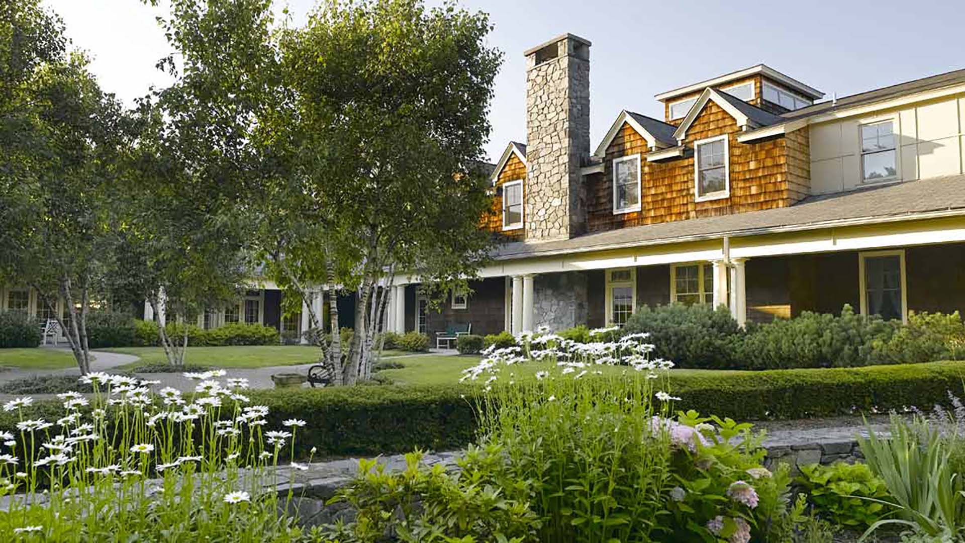 Exterior view of the community with winding walking paths covered by large trees