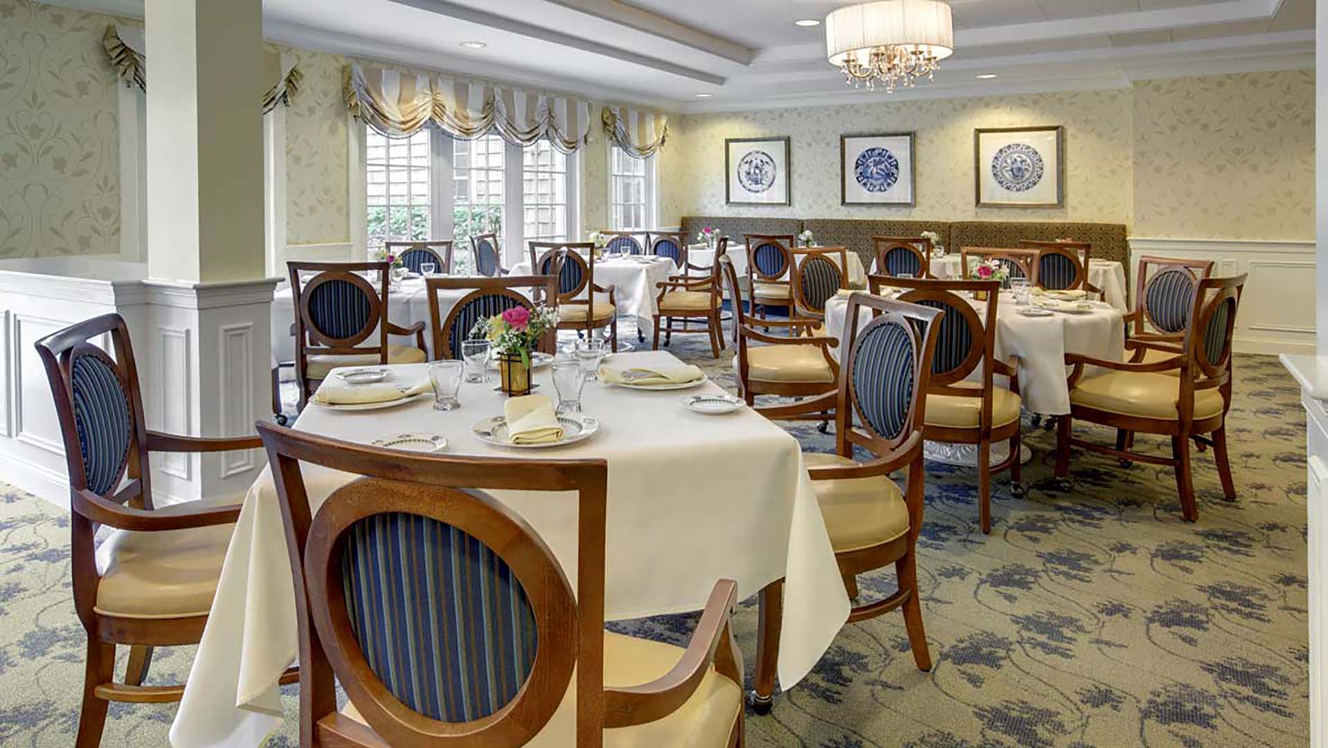 Community dining room featuring blue-and-gold tables, carpet and chairs
