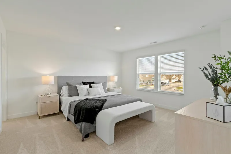 Primary bedroom with large bed and dresser