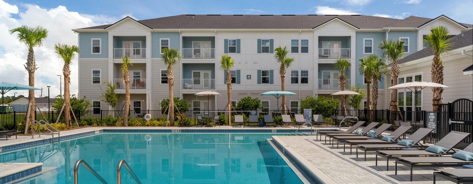a large white building with a pool